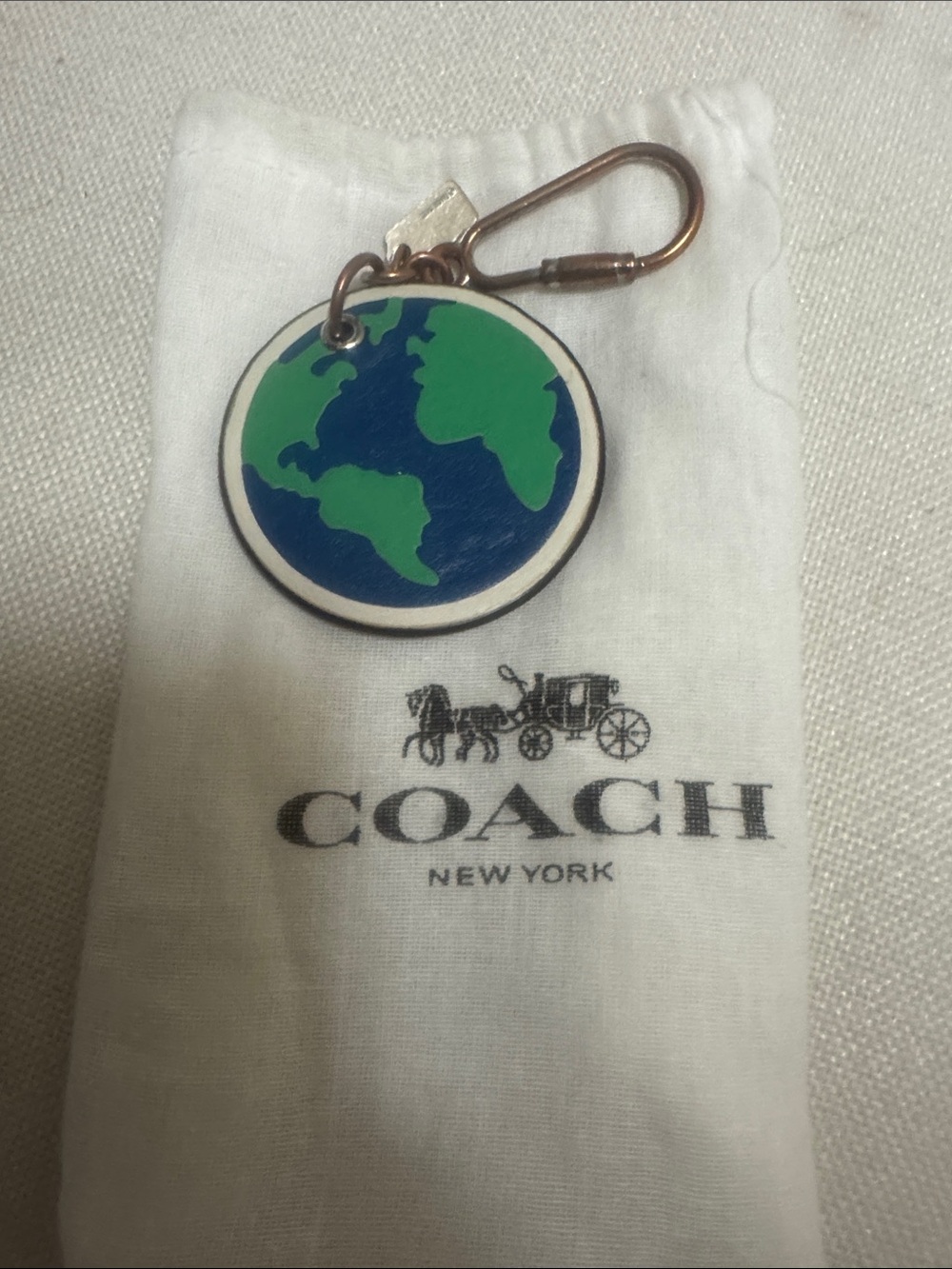 Like New- Coach vintage leather “ Earth” key chain .